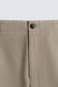PLEATED CHINO PANTS
