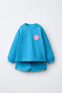 ENSEMBLE SWEAT ET BERMUDA À FLEUR GOMMÉE