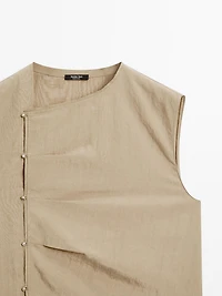 Blouse with silver button fastening on the side