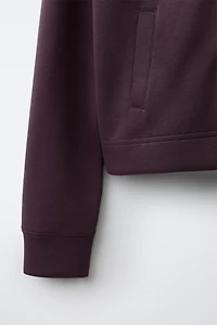 VESTE DE SPORT À CAPUCHE