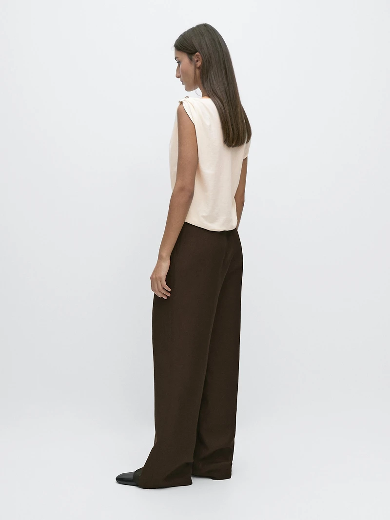 Asymmetric top with shoulder appliqué