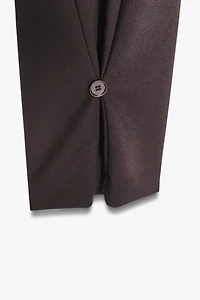 PLEATED PANTS WITH BUTTON HEM