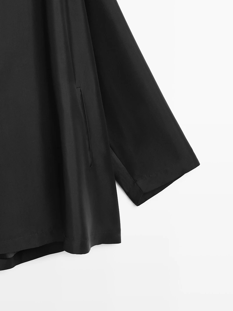 Flowing voluminous cape with button details