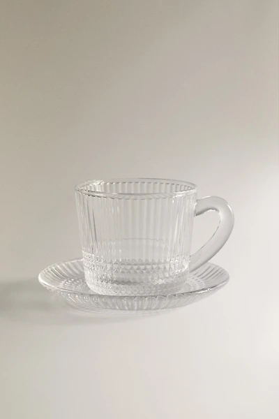 COFFEE CUP AND SAUCER WITH RAISED GEOMETRIC DESIGN