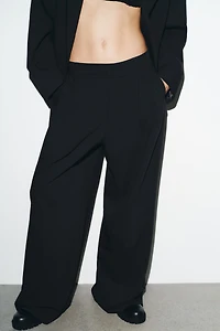 PINSTRIPE PANTS WITH PLEATS AND FLAPS