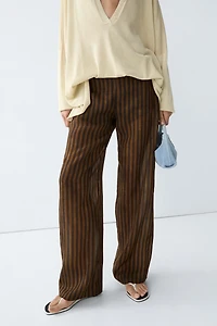 Total look flowing striped pants with button hem