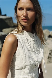 EMBROIDERED EYELET TOP WITH FROG FASTENING