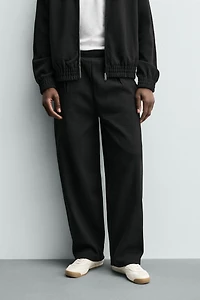 PLEATED WIDE FIT JOGGER PANTS