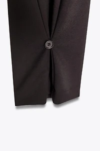 PLEATED PANTS WITH BUTTON HEM