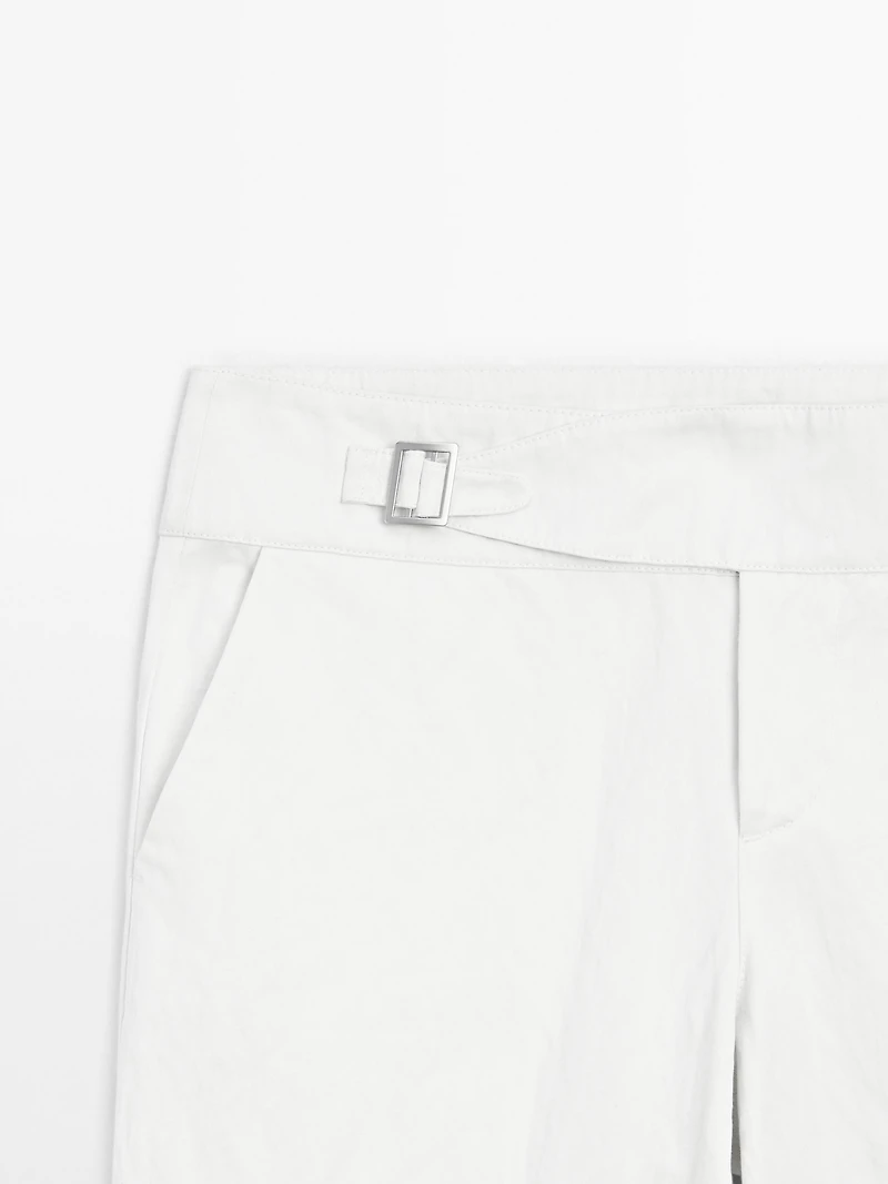 Slim fit low-rise trousers with buckles