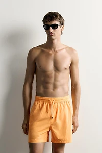 WASHED EFFECT LONG SWIM TRUNKS