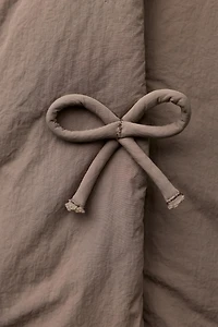 WATER REPELLENT PUFFER COAT WITH BOWS