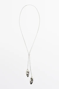 Adjustable necklace with textured pieces