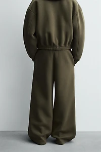 WIDE FIT NEOPRENE EFFECT PANTS WITH STUDS