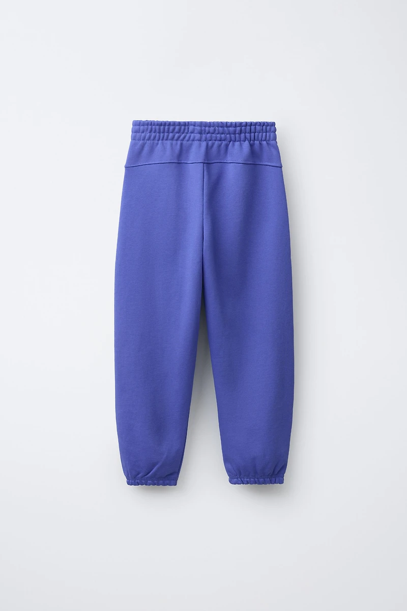PANTALON JOGGER EN MOLLETON AVEC TEXTE