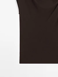 Asymmetric top with knot detail