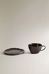 STONEWARE COFFEE CUP AND SAUCER WITH RAISED DESIGN