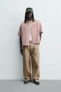 PLEATED WIDE FIT CHINO PANTS