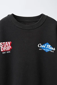 RAISED TEXT SWEATSHIRT