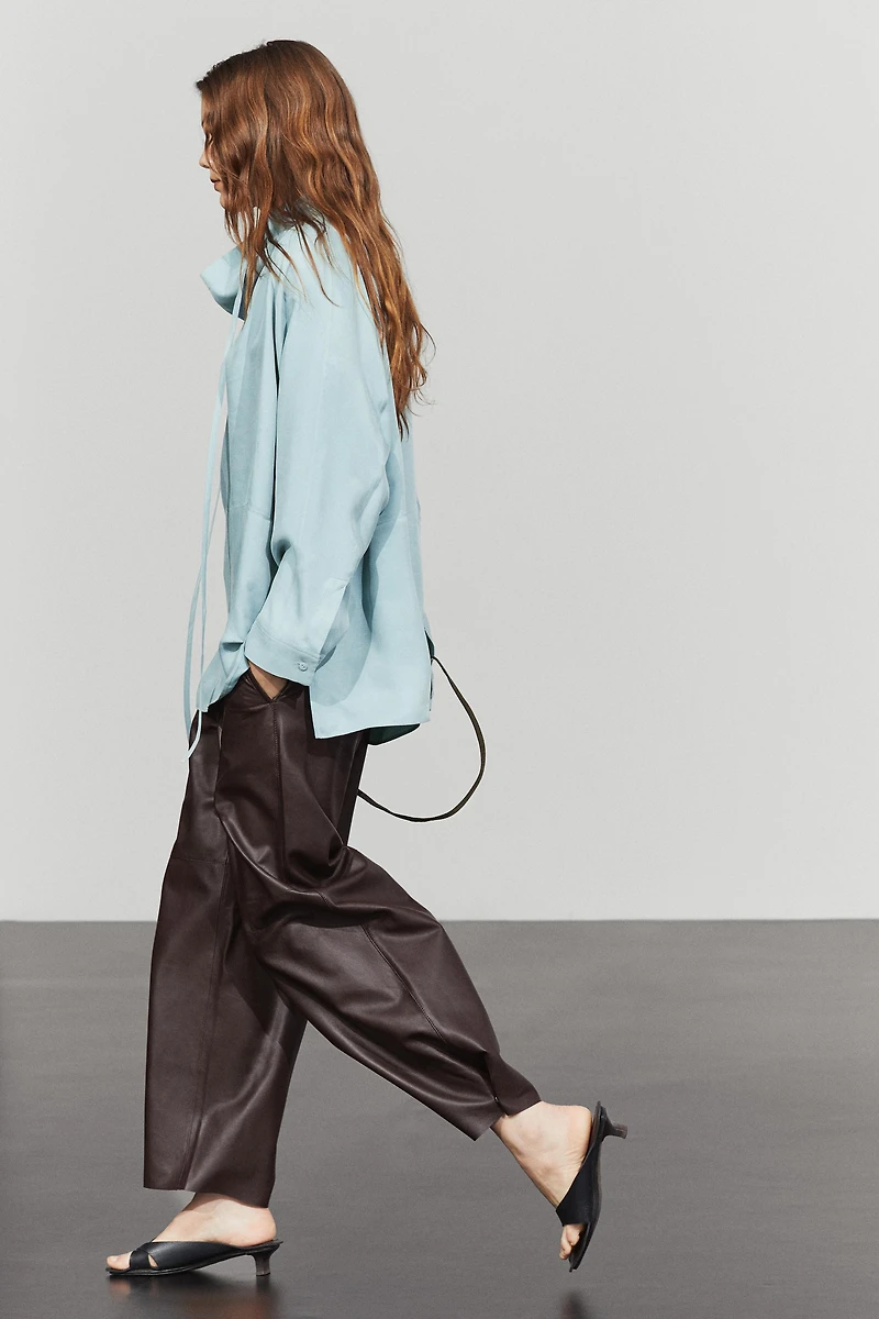 Flowing shirt with high collar and drawstring detail