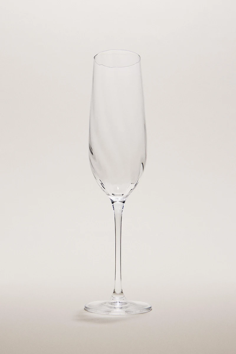 CRYSTALLINE FLUTE GLASS WITH RAISED DESIGN