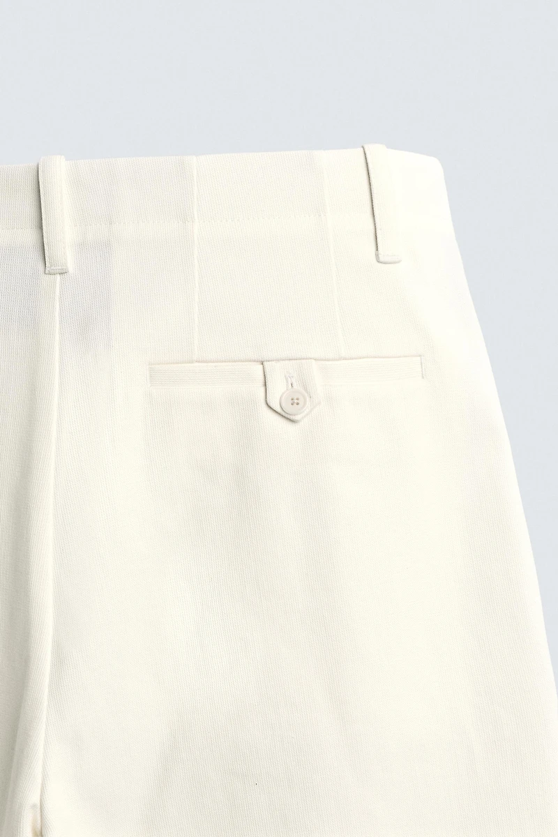 PLEATED WIDE FIT CHINO PANTS