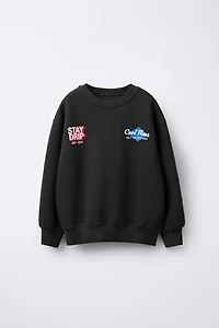 RAISED TEXT SWEATSHIRT