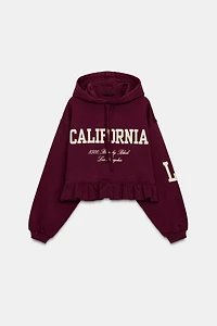RUFFLED VARSITY SWEATSHIRT