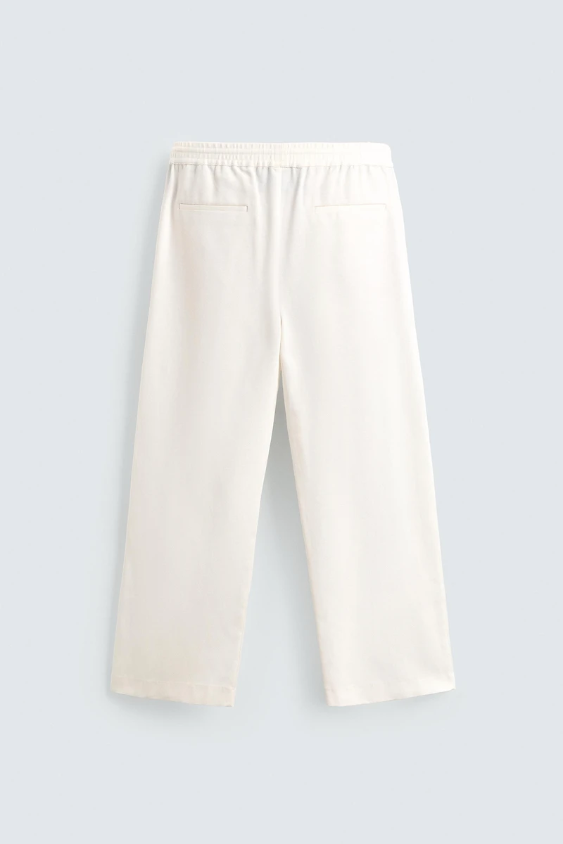TEXTURED PLEATED PANTS