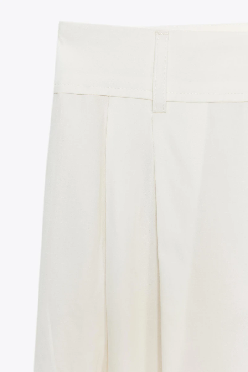 PLEATED PANTS WITH FLAPS