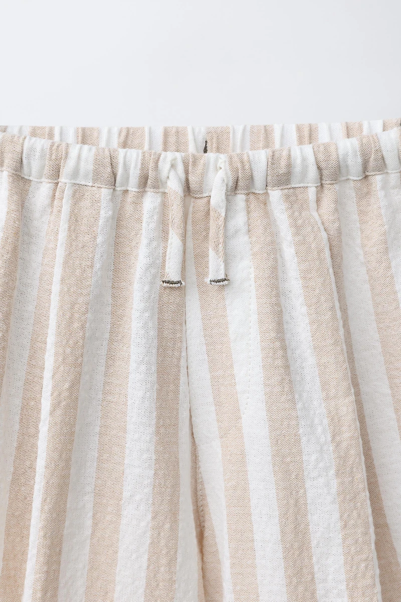 PANTALON BALLON À PLIS ET RAYURES