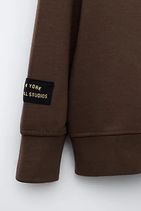 VARSITY INTERLOCK SWEATSHIRT