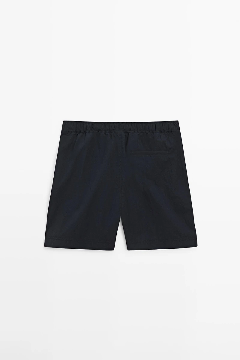 Plain swimming trunks with waist detail