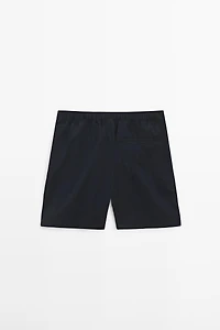 Plain swimming trunks with waist detail