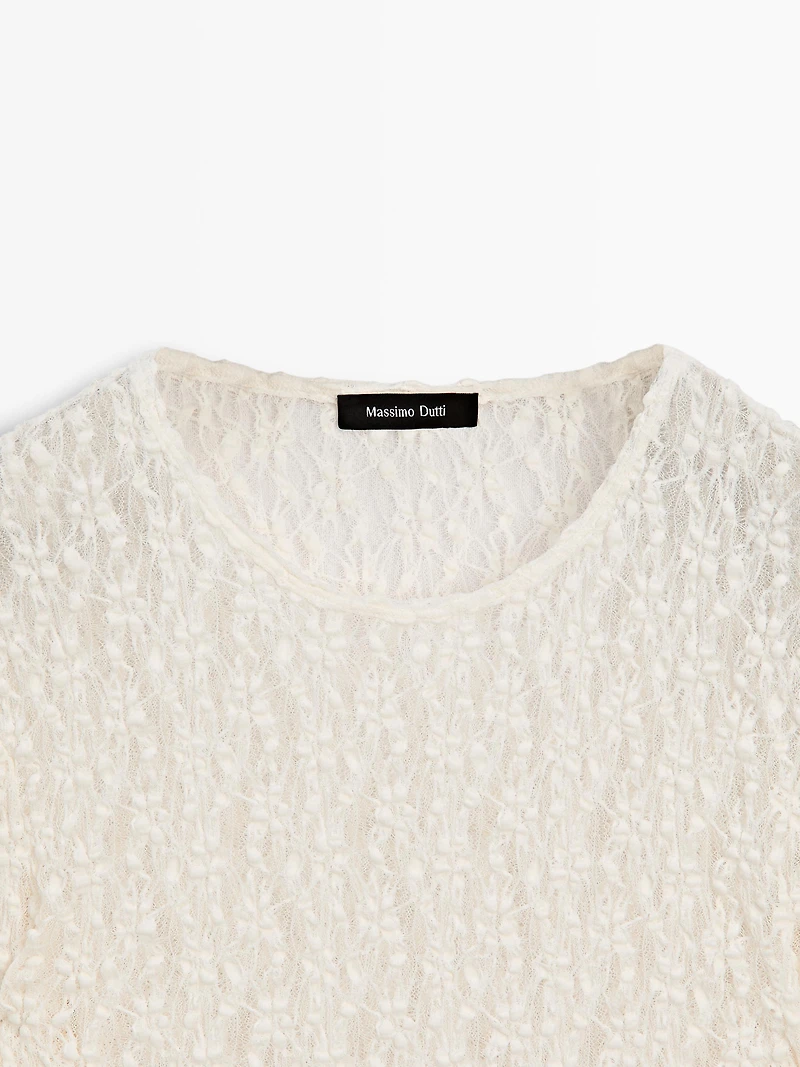 Openwork knit top with long sleeves and lace