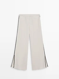 Linen trousers with contrast piping