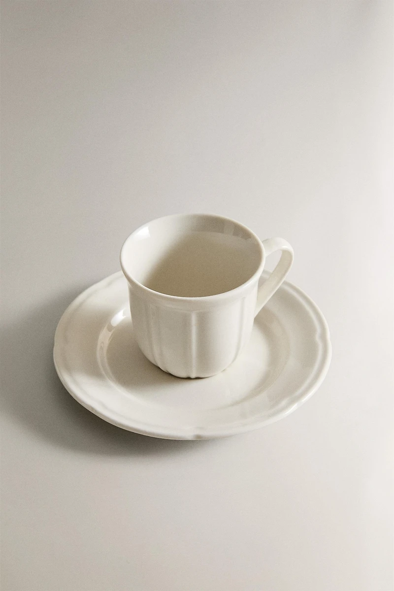 COFFEE CUP AND PORCELAIN SAUCER WITH RAISED DESIGN