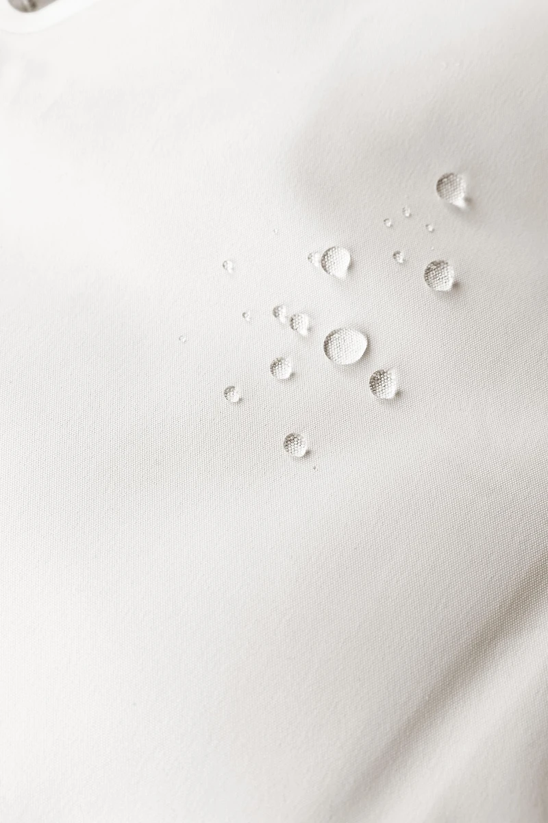 WATER RESISTANT AND WINDPROOF RECCO® SYSTEM SKI COLLECTION LONG JUMPSUIT WITH FAUX FUR HOODIE