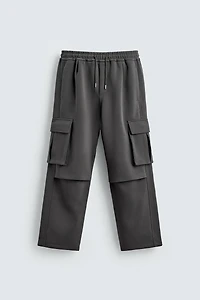 NEOPRENE EFFECT CARGO PANTS WITH PLEATS