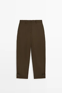 Pants with button-tab hem detail