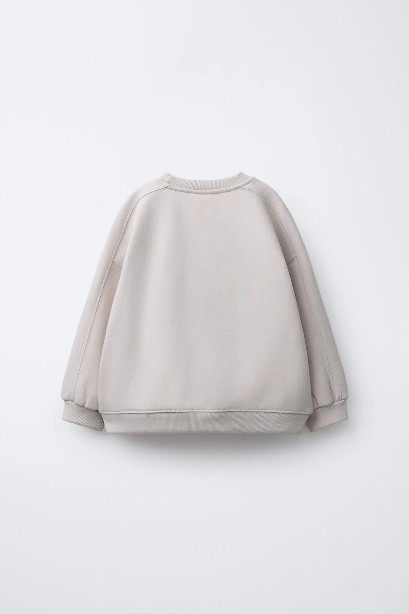 RAISED TEXT SWEATSHIRT