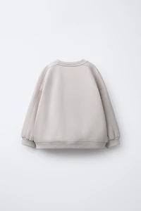 RAISED TEXT SWEATSHIRT