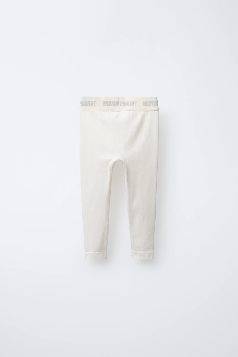 LEGGING CÔTELÉ AVEC INSCRIPTION EN RELIEF
