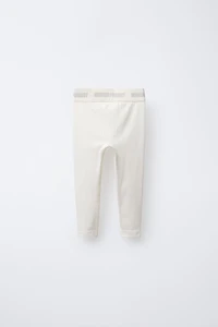 LEGGING CÔTELÉ AVEC INSCRIPTION EN RELIEF