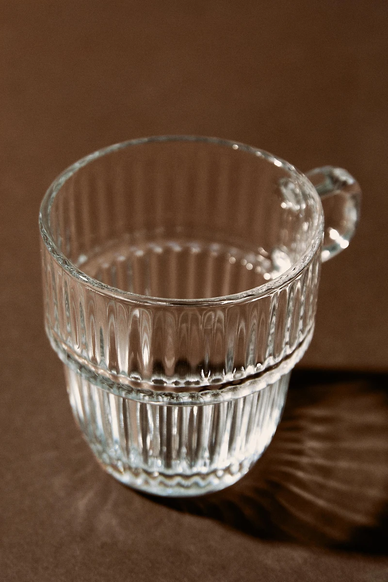 GLASS CUP WITH RAISED DESIGN