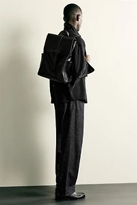 BELTED FLAP BACKPACK
