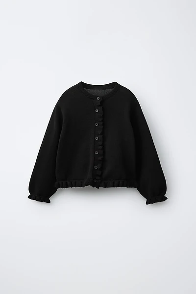 GILET EN MAILLE À PETIT VOLANT