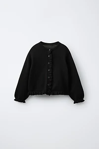 GILET EN MAILLE À PETIT VOLANT