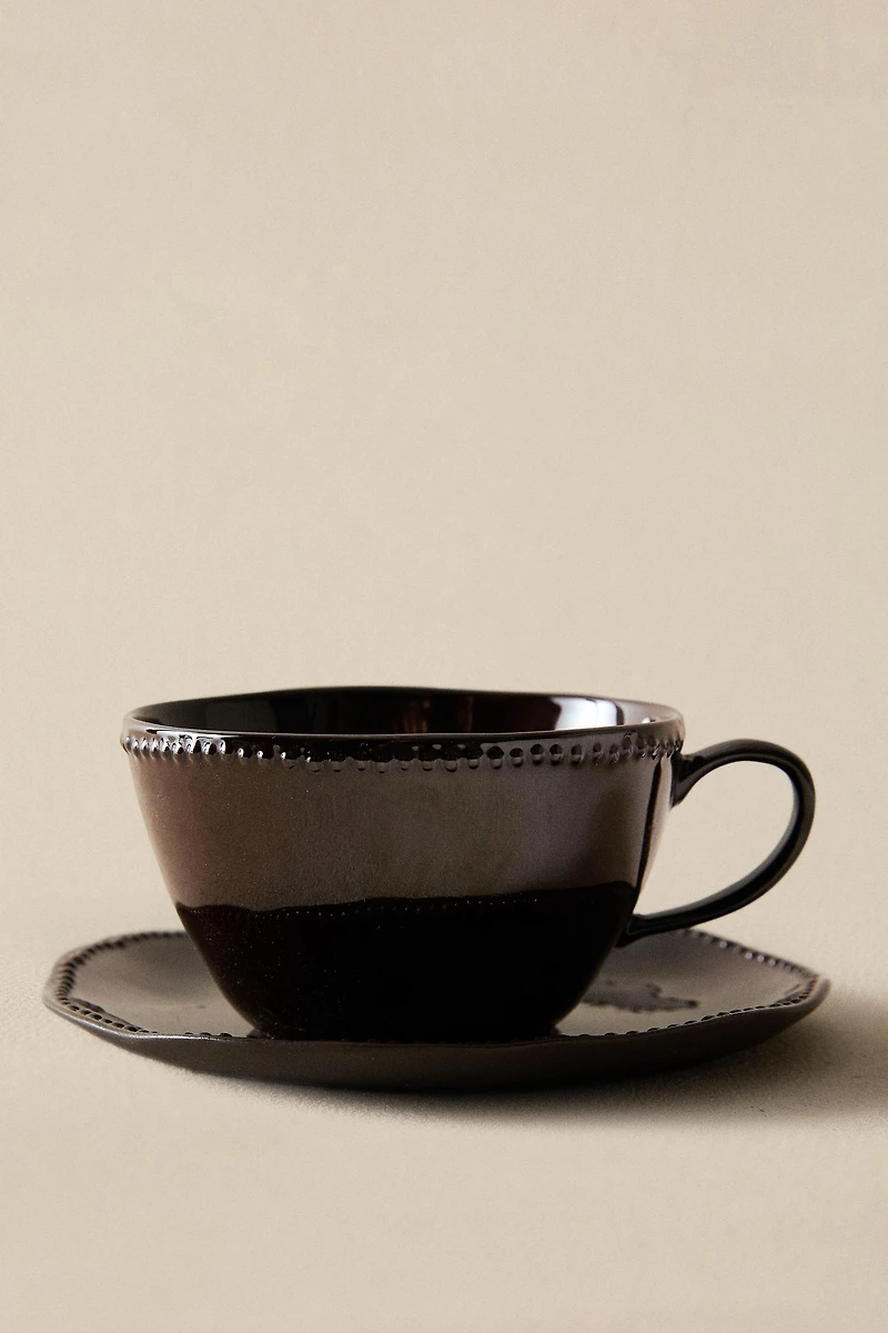 STONEWARE COFFEE CUP AND SAUCER WITH RAISED DESIGN