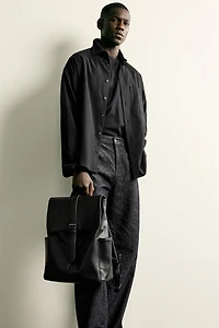 BELTED FLAP BACKPACK